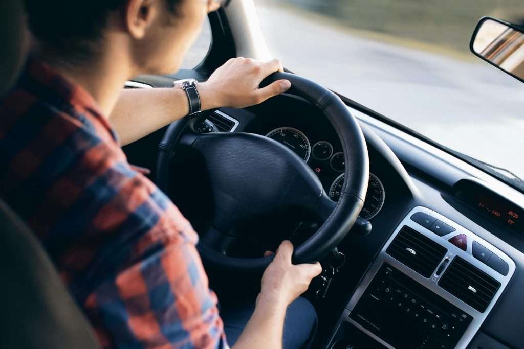 Man driving car, focusing on road