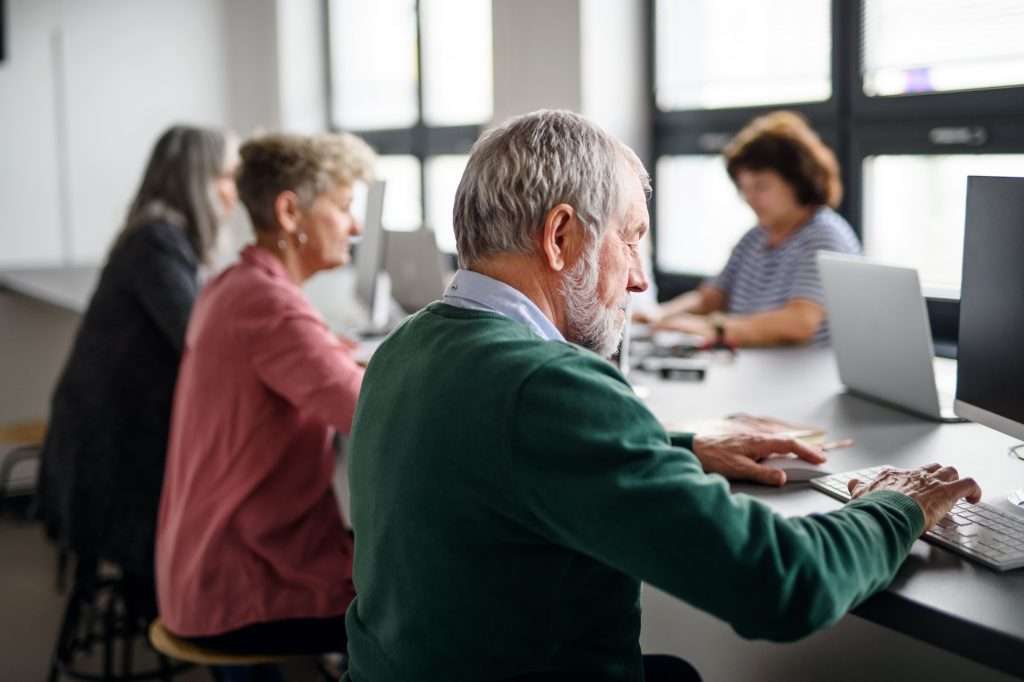Senior adults attending computer class