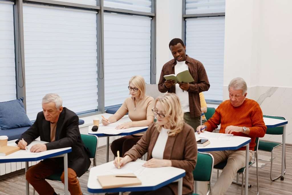 Diverse adults studying in a modern classroom setting